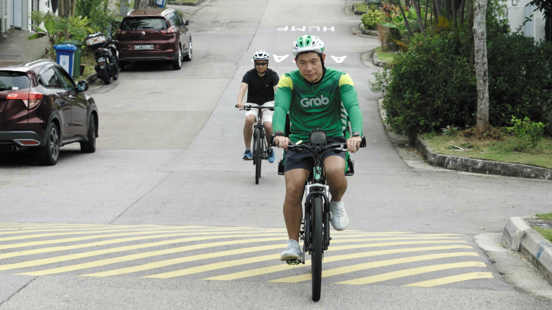 Longtime friends Anthony Tan (front) and Jixun Food (back) out on a GrabFood delivery run.